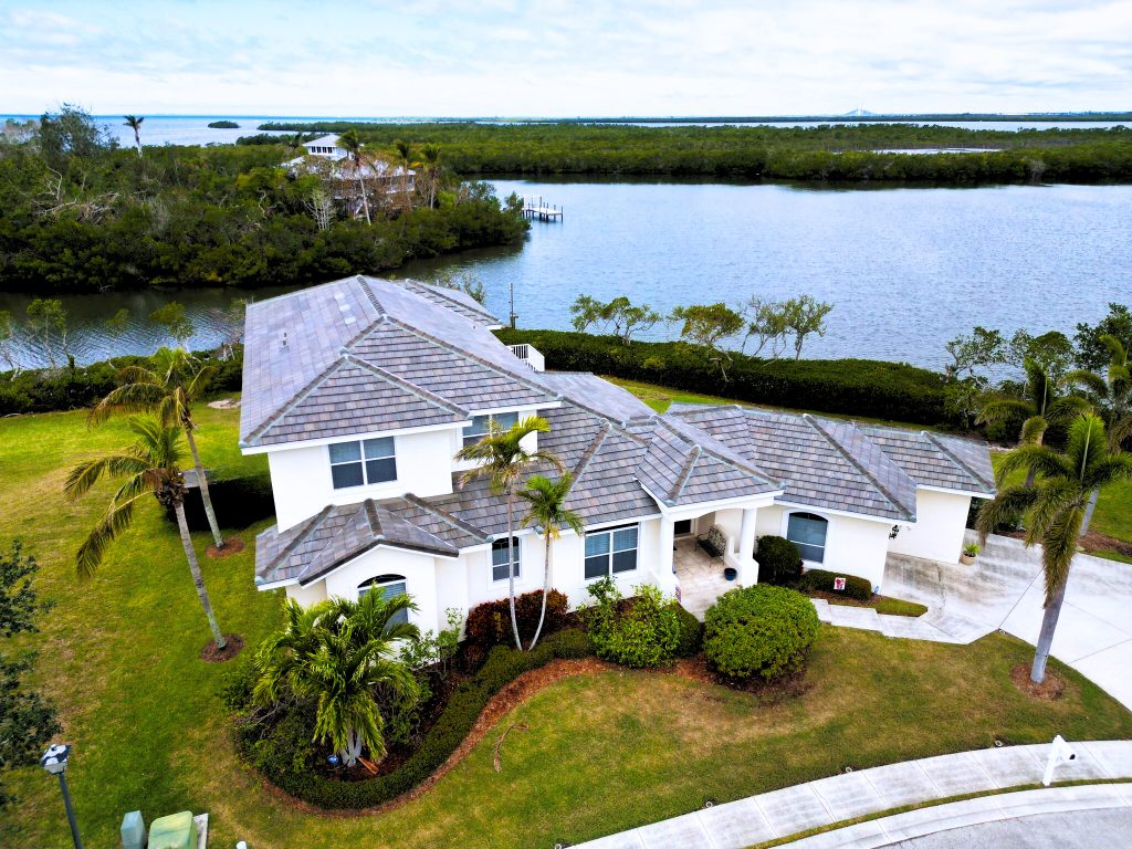 waterfront property with a shingle roof